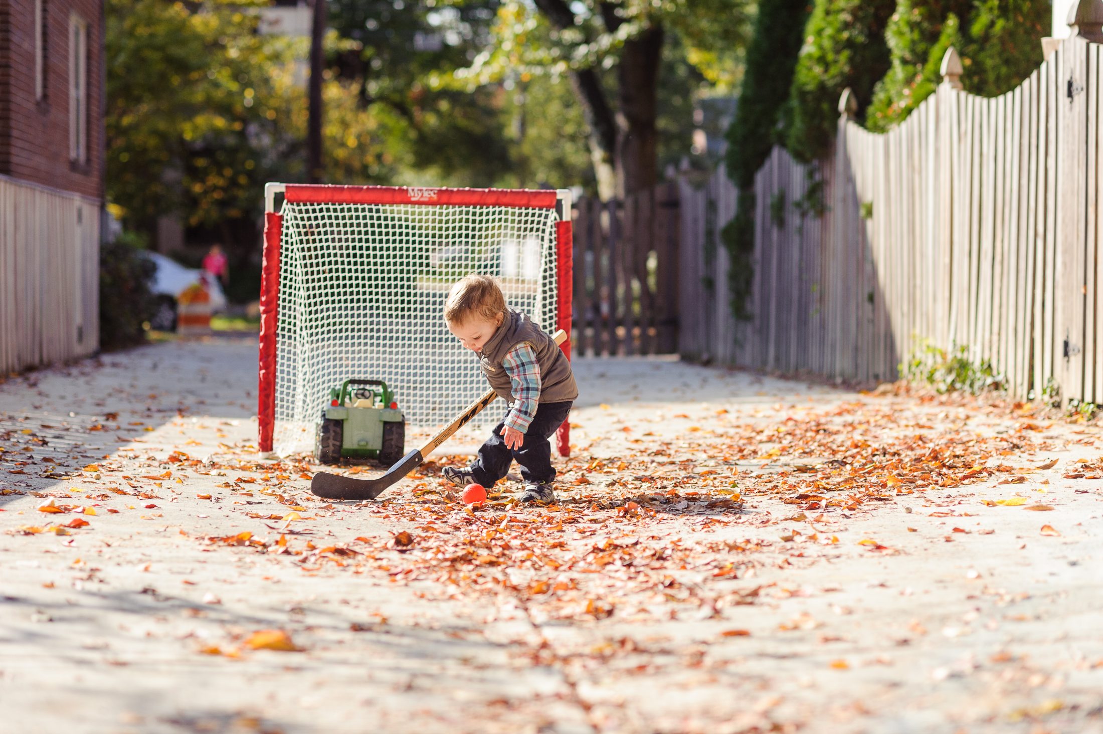 Tommy Brimley playing hockey in alley by Brimley house