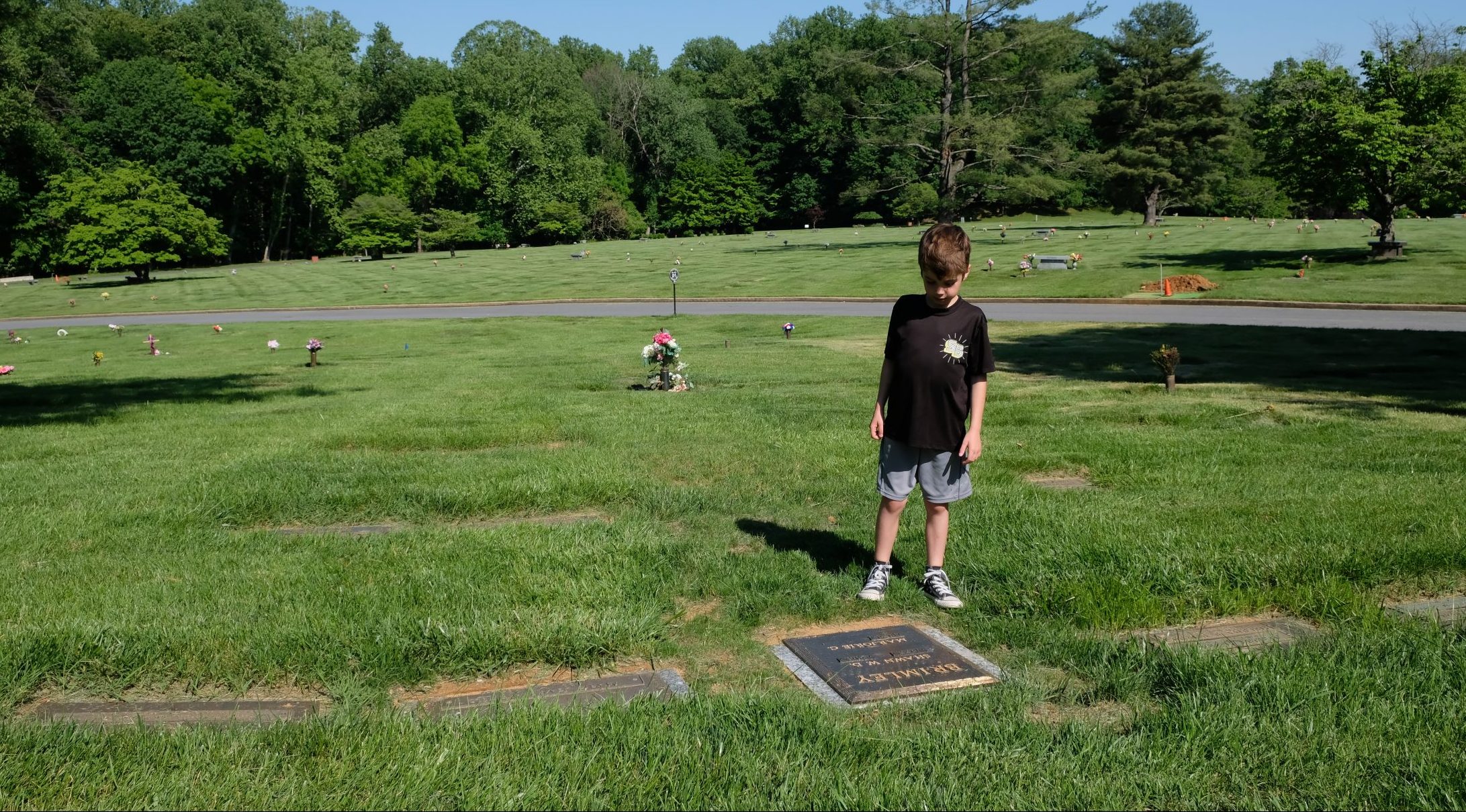 Austin Brimley looking at Shawn Brimley's grave outside DC
