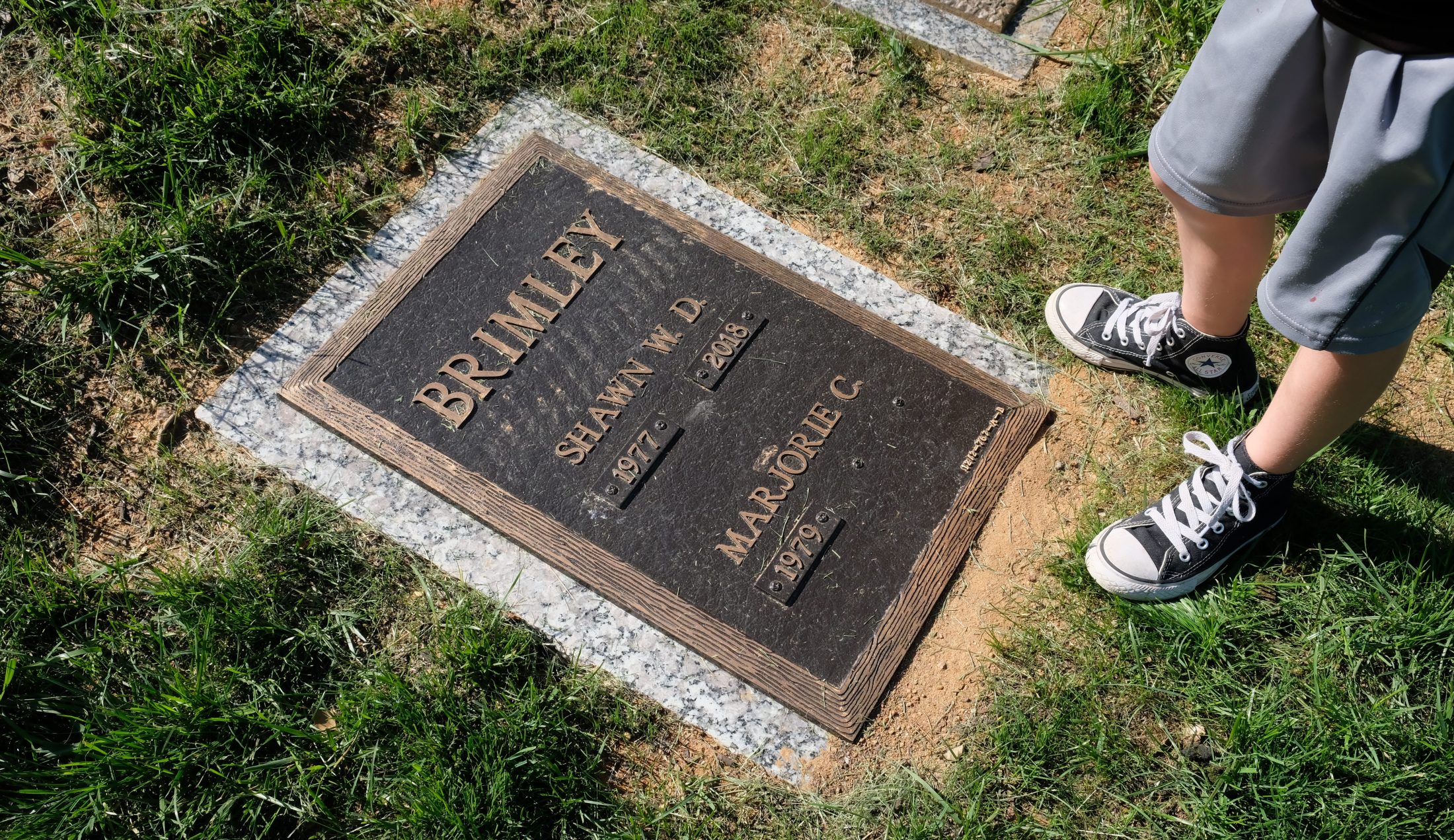 Shawn Brimley's grave with Austin's converse and Marjorie's name appearing as a widow