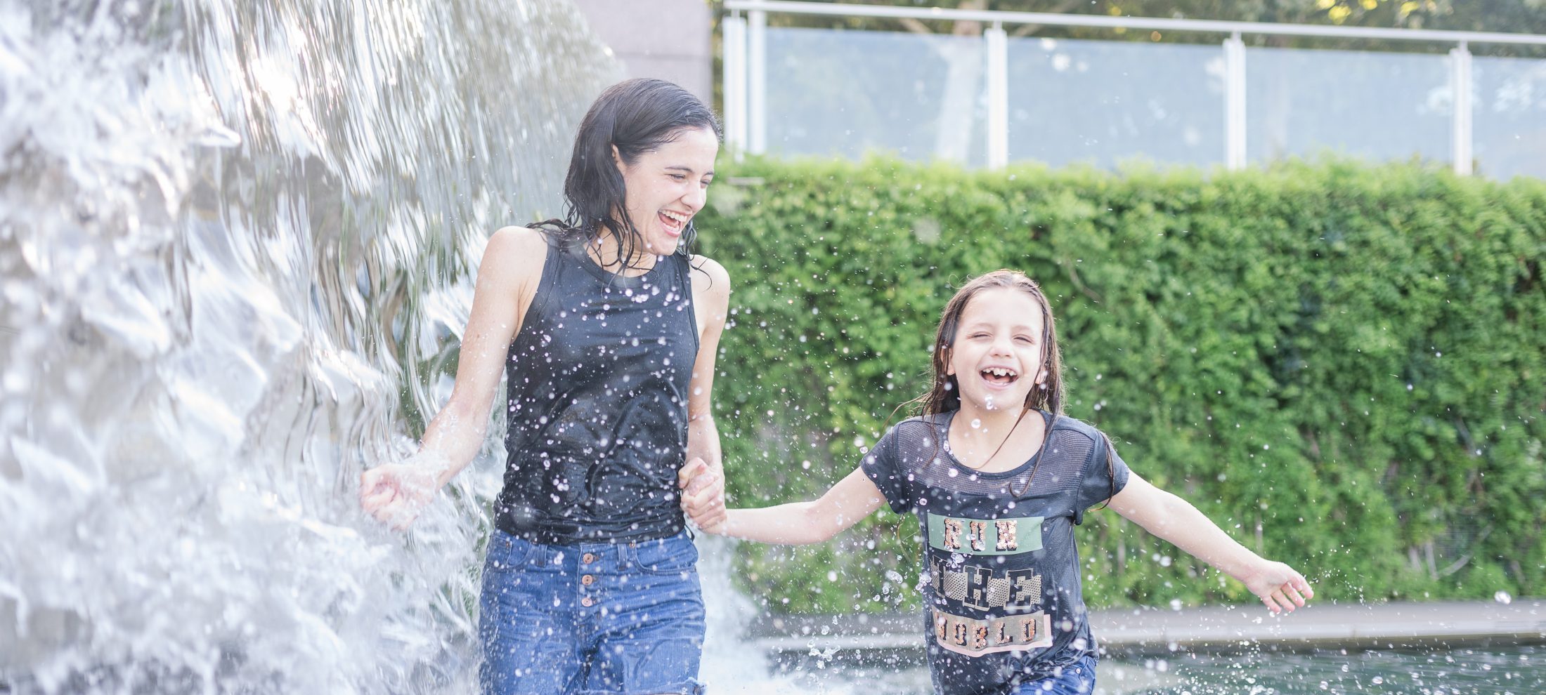 Marjorie Brimley and her daughter running through a fountain in DC after Shawn's death