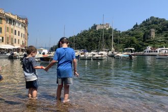 Children of DC widow blog writer Marjorie Brimley play in the sea with boats nearby