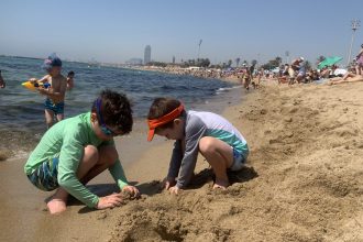 Children of DC widow blog writer Marjorie Brimley build a sandcastle on the beach
