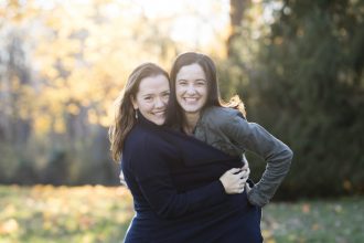 DC widow blog writer Marjorie Brimley hugs her friend Michelle in field