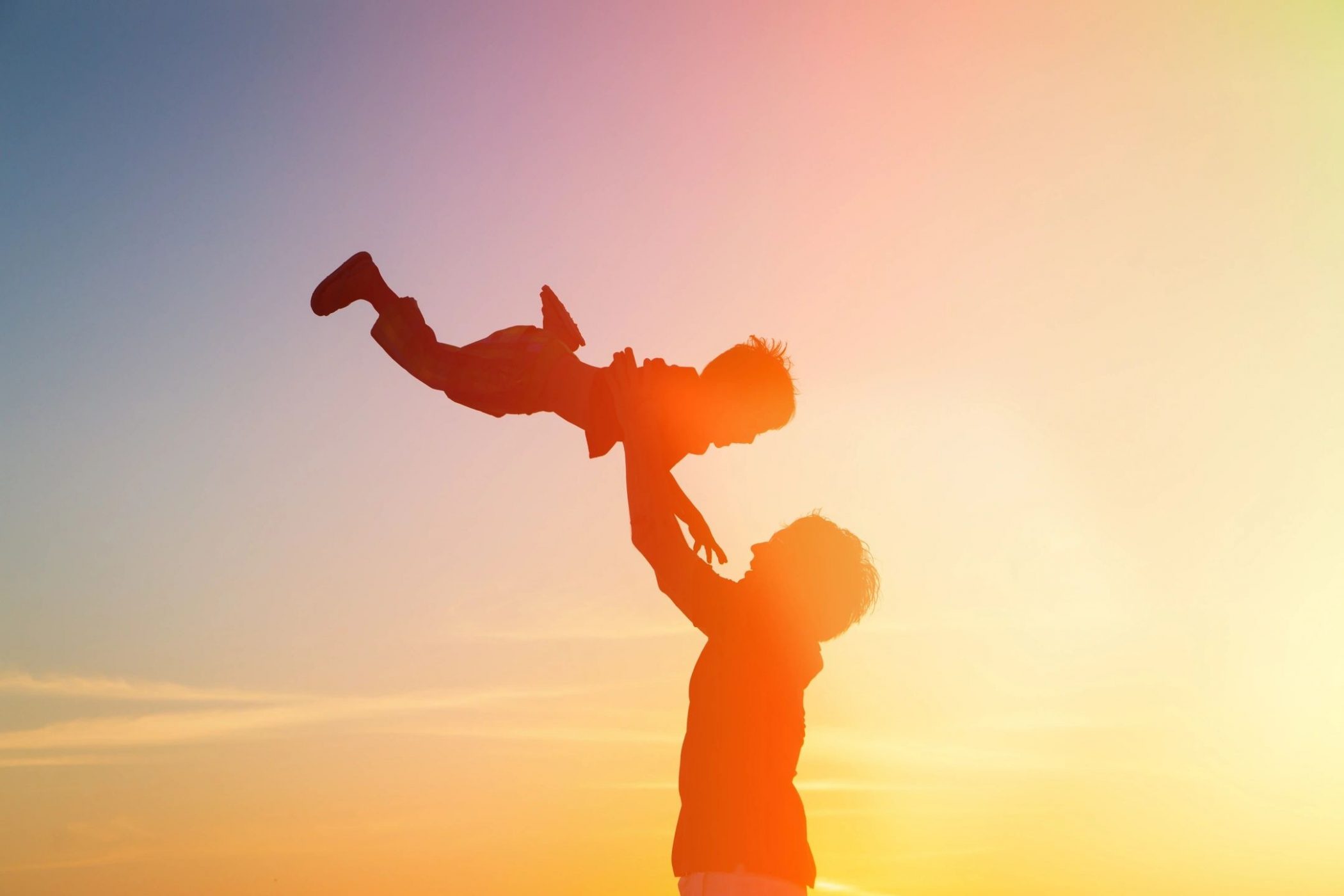 Parent swinging child in sunset like in story by DC widow blog writer Marjorie Brimley