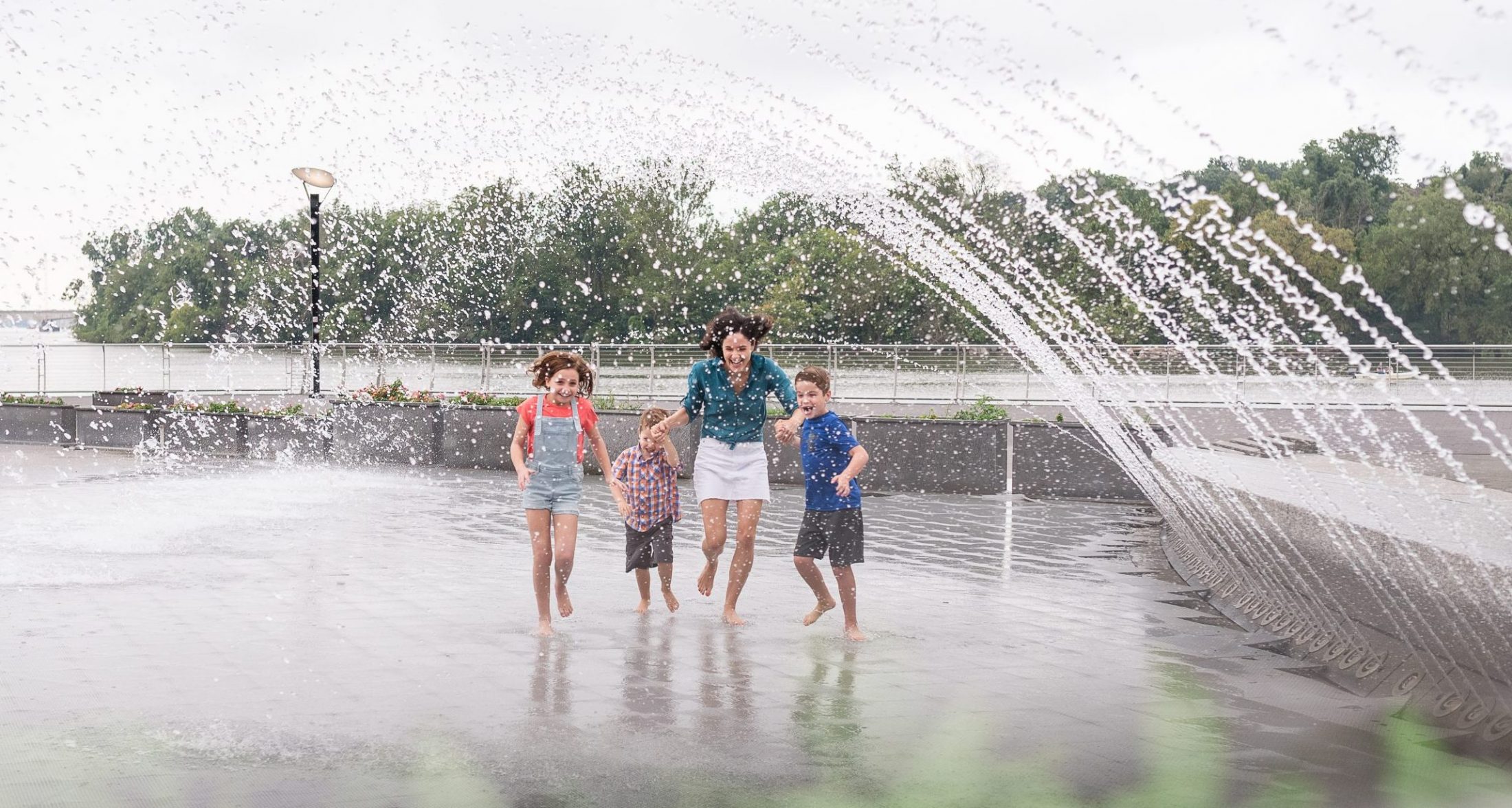 DC widow blog writer Marjorie Brimley runs through fountain with children