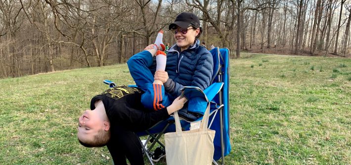 DC widow blog writer Marjorie Brimley plays with son while sitting in a chair at park