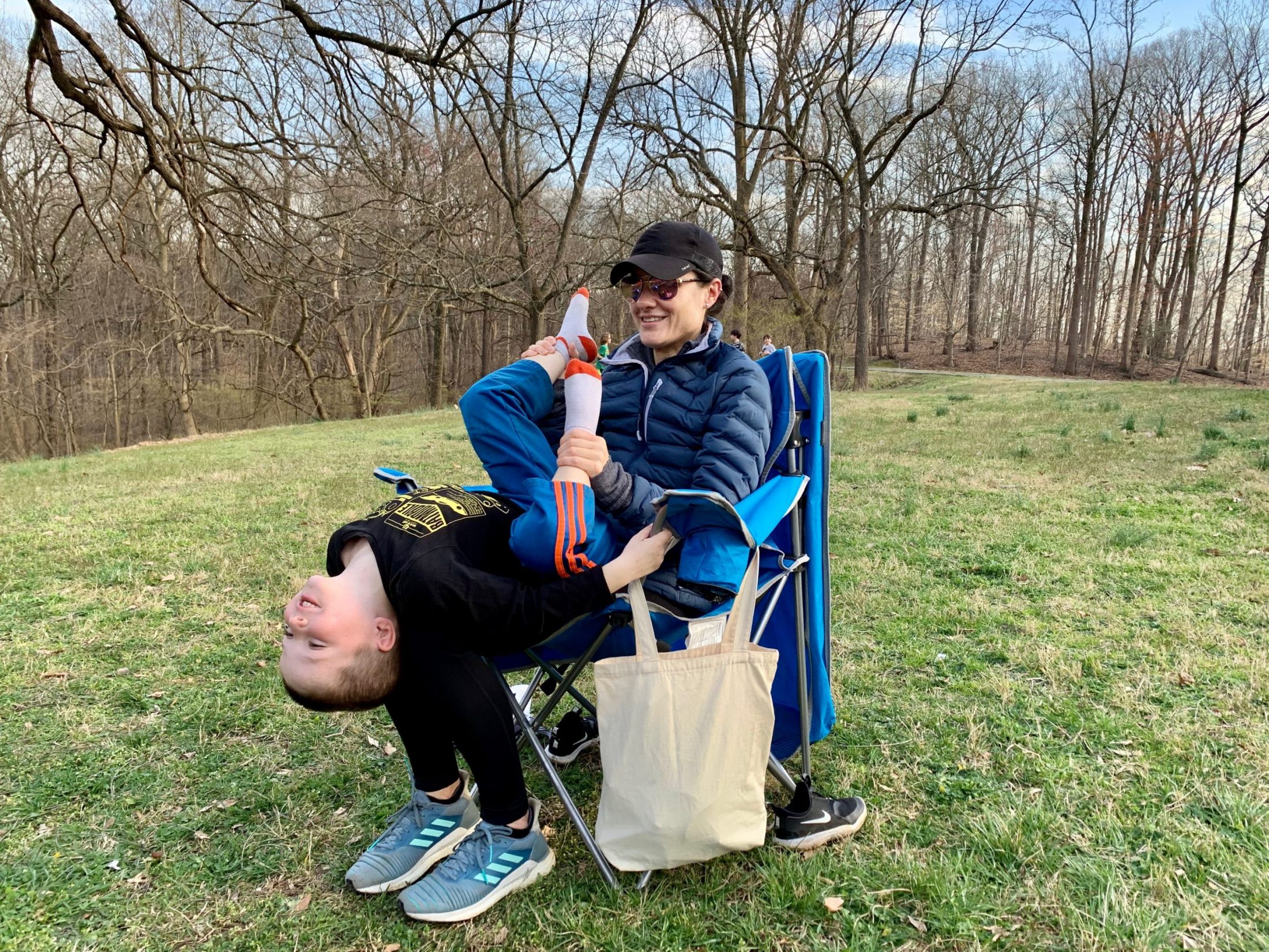 DC widow blog writer Marjorie Brimley plays with son while sitting in a chair at park