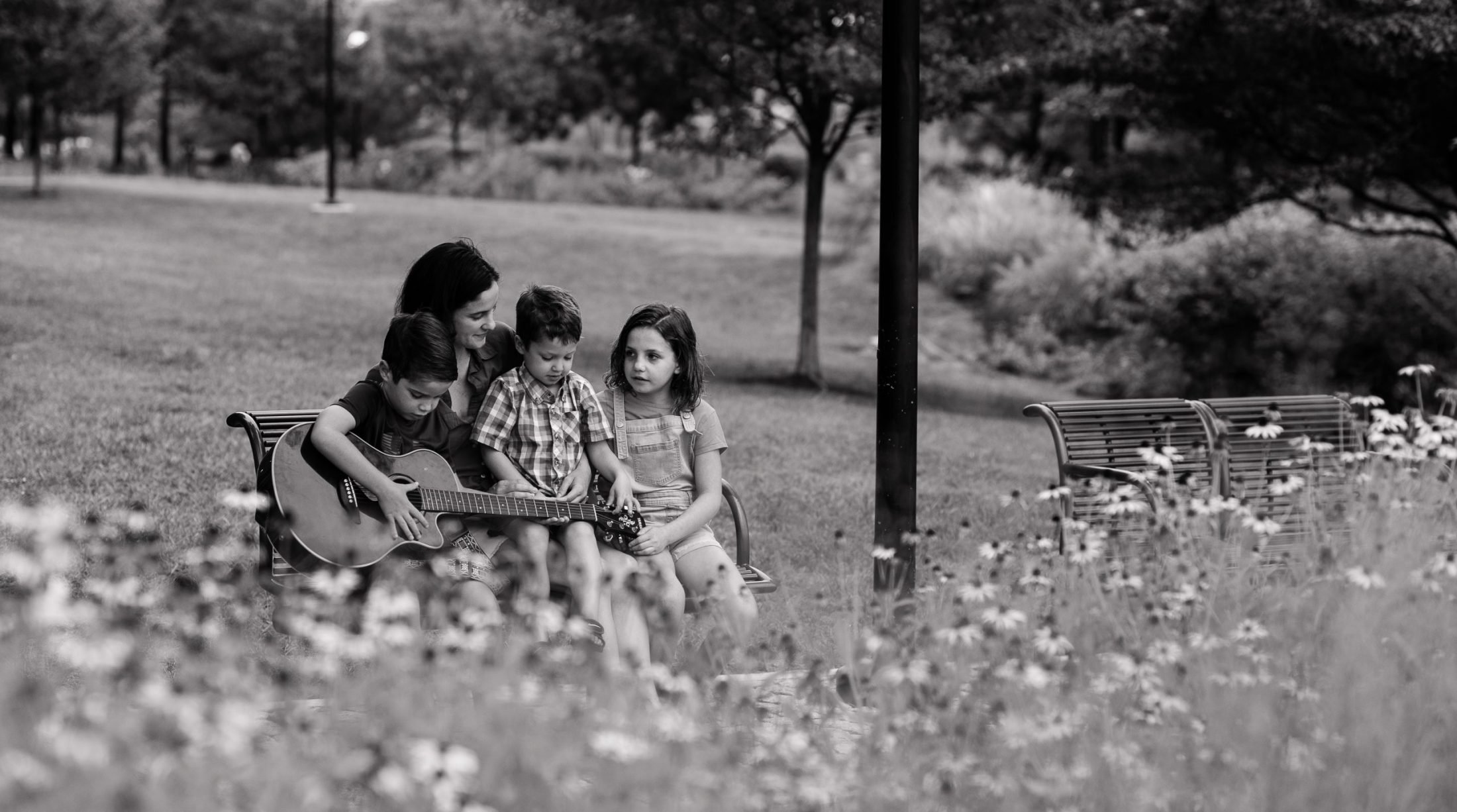 DC widow blog writer Marjorie Brimley sits on bench in park with children