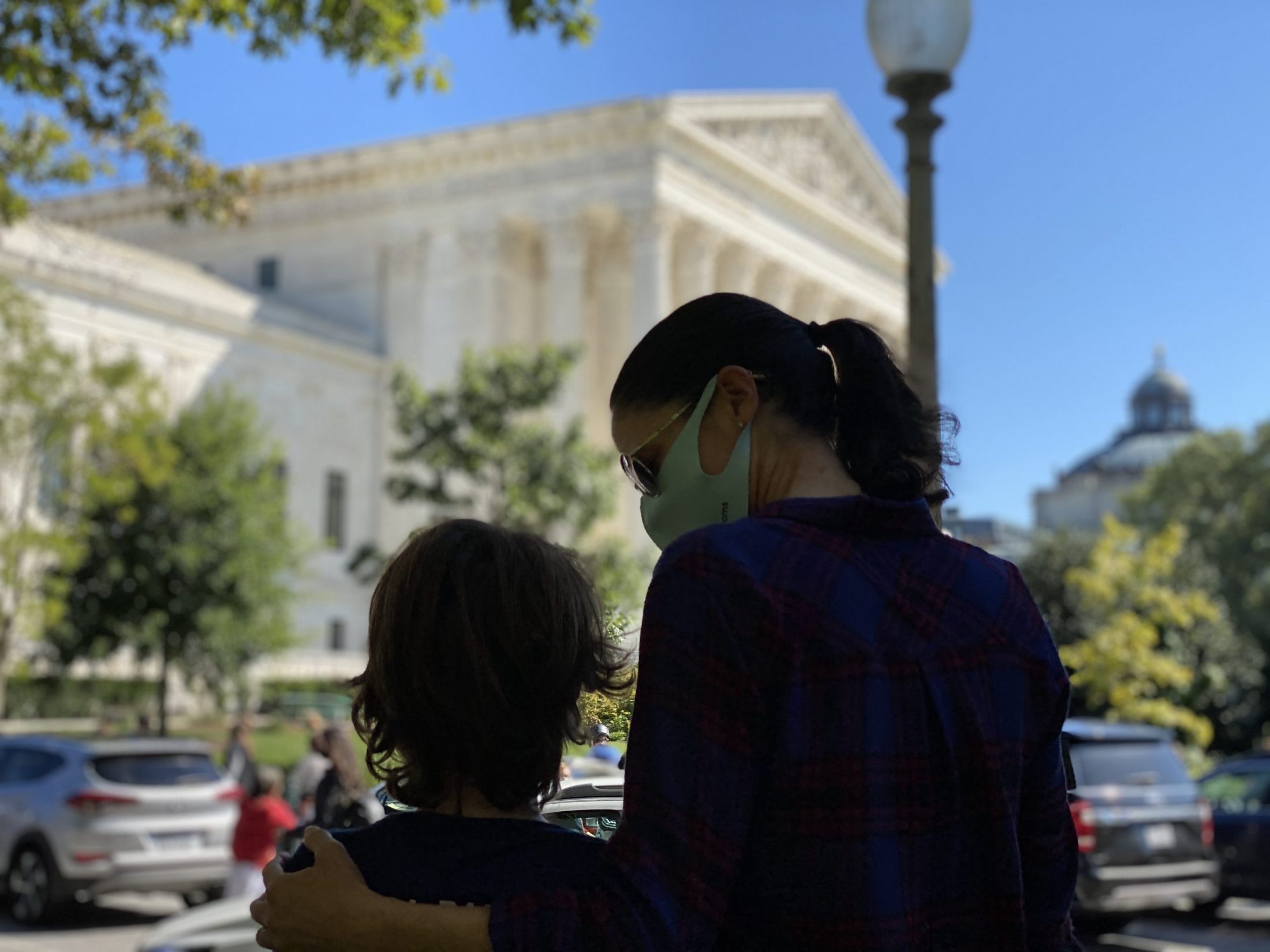DC widow blog writer Marjorie Brimley hugs son Austin in front of Supreme Court