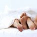 Two pairs of feet in bed for dating blog by DC widow writer Marjorie Brimley Hale