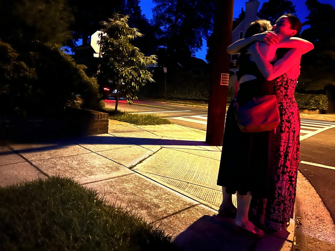 DC widow blog writer Marjorie Brimley Hale hugs friend Michelle at night