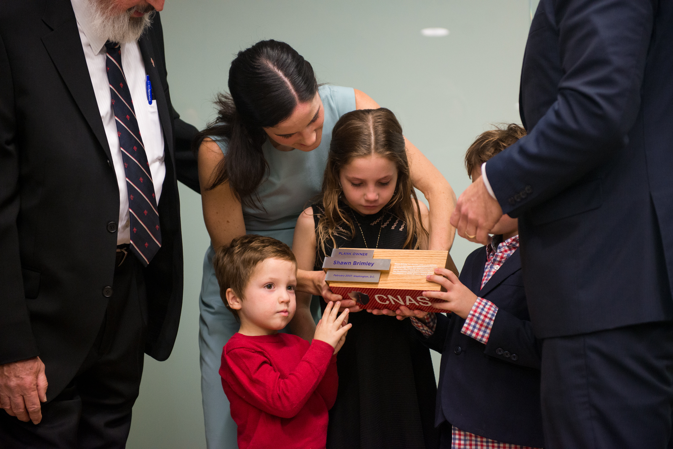 Shawn Brimley's widow Marjorie accepts plaque with her children at DC think tank