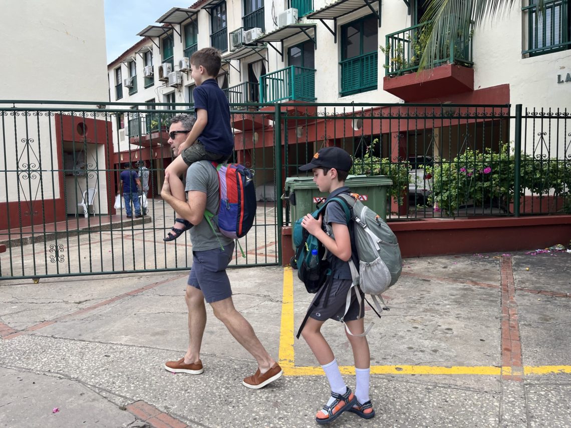 Austin and Chris walk in street for blog by DC widow writer Marjorie Brimley Hale